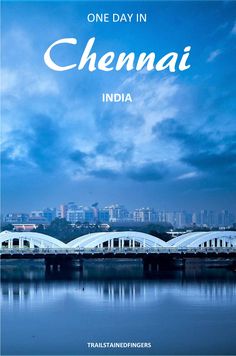 the cover of one day in chemai, india with a train crossing over water