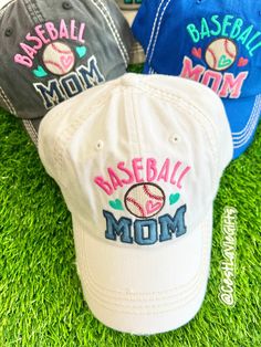 three baseball mom hats sitting on the grass