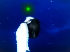 a woman standing in front of a blue sky with stars and a green star above her head