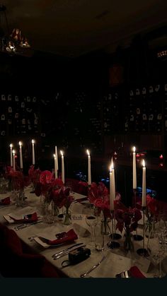 a long table is set with candles and place settings