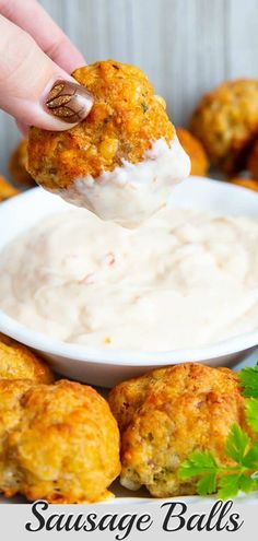 a person dipping some food into a bowl with ranch dressing on the side and another hand reaching for it