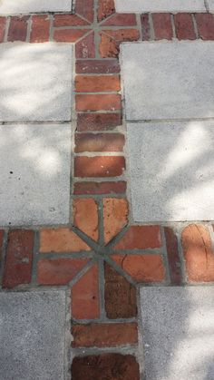 a cross made out of bricks on the ground