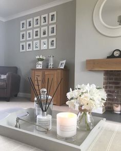 a living room filled with furniture and flowers on top of a tray next to a fire place