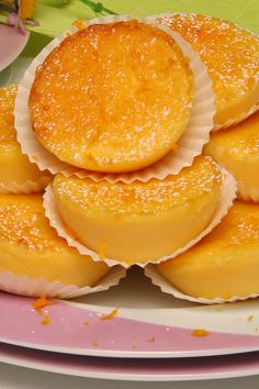 a plate topped with yellow desserts on top of a pink and white table cloth