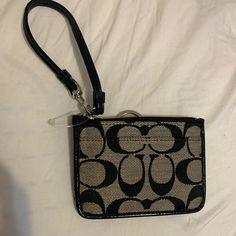 Paper Still In It. Never Used. Coach Keychain/Wallet. Great Condition Black Clutch Wallet With Wrist Strap, Black Rectangular Wristlet With Zipper Closure, Coach Black Wristlet With Zipper Pouch, Chic Coach Coin Purse With Card Slots, Coach Black Wristlet With Removable Pouch, Coach Black Clutch With Zipper Pouch, Black Wristlet With Zipper For Everyday Use, Black Rectangular Wristlet With Zipper Pouch, Black Wristlet With Adjustable Strap For Daily Use