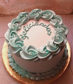 a white cake with blue frosting and the words happy birthday written in large letters