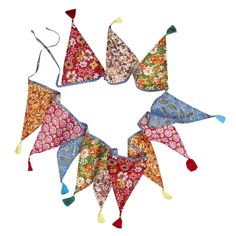 four kites with tassels are arranged in the shape of a flowered triangle