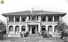 an old photo of a large house with many windows