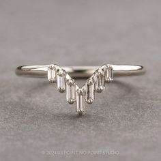 a white gold ring with three baguettes on it