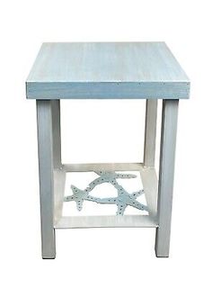 a white and blue side table with starfishs on the bottom, against a white background