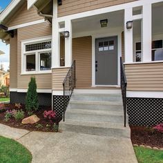 a house with two front porches and steps leading up to the entry door,