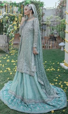 a woman in a blue and green wedding outfit