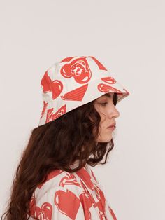 Despite appearances, I will never have the heart to tell you when you’ve got something stuck in your teeth. We love a bucket hat. This one is in our standard shape, with a nice wide brim and a red and white smiley heart design water printed on the hat, which is made from a thick and durable cotton twill. If you love the print, there’s also a matching shirt and shorts set available, as well as a pair of socks in the same design. Matching Shirt And Shorts, Heart Bucket Hat, Repeat Prints, Water Printing, Bowling Shirt, Revere Collar, Lazy Oaf, Boiler Suit, Custom Buttons