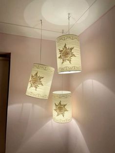 three lamps hanging from the ceiling in a room