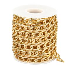 a spool of gold chain on a white background