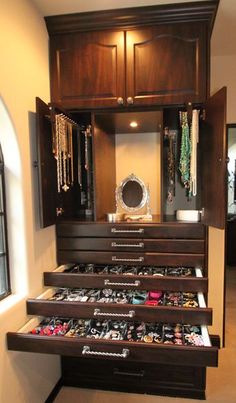 an organized closet with lots of shoes and necklaces in the drawers on each shelf