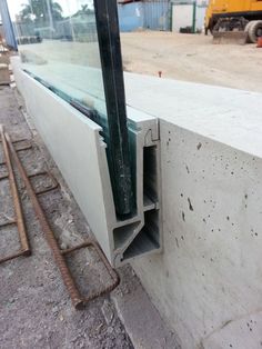 an open window sitting on the side of a building next to a construction site with machinery in the background