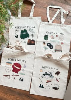 two totes bags sitting on top of a wooden floor next to a christmas tree