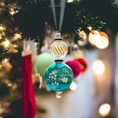 a glass ornament hanging from a christmas tree