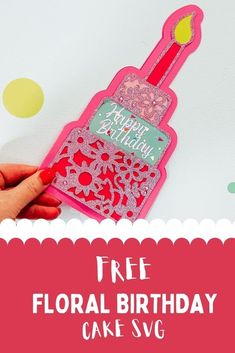 a hand holding a pink birthday card with the words free floral birthday cake svg