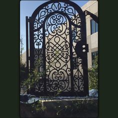 an ornate iron gate in front of a building