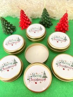 six christmas tins sitting on top of a green table