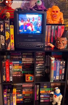 there is a television that is on top of a bookshelf filled with movies