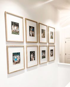 a white wall with many pictures hanging on it's sides and a door in the background