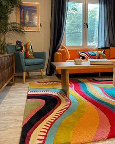 a living room filled with furniture and colorful rugs