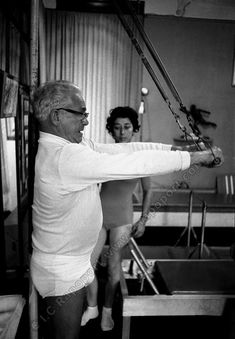 black and white photograph of an old man swinging a baseball bat