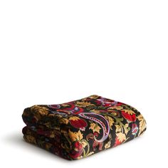 two bedspreads with colorful designs on them sitting side by side in front of a white background