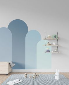 an empty room with blue walls and shelves on the wall is decorated in pastel colors