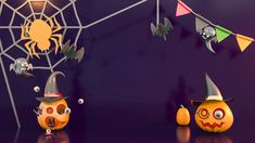 three pumpkins with hats and decorations hanging from the ceiling in front of a spider web