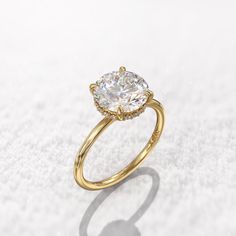 a yellow gold ring with a large diamond