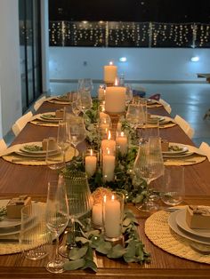 a long table with candles and place settings