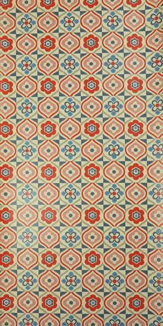 an old carpet with red and blue designs on it