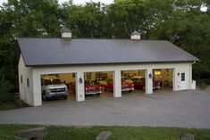 two cars are parked in the garage with their doors open