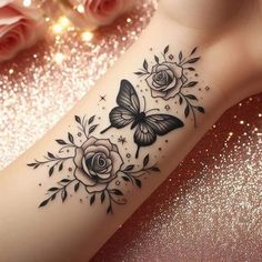 a black and white tattoo on the arm with roses, butterflies and stars around it