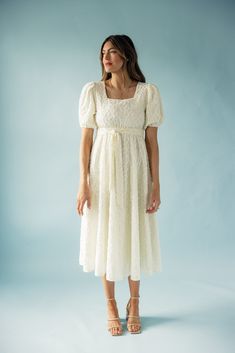 This enchanting white dress, adorned with intricate floral appliqués, captures the essence of romance and sweet nostalgia. Complete with a puff sleeves, a square neckline, and a waist tie, the Beth whispers of quiet strength, kindness, and the beauty found in life's simple moments. keyhole back with button closure waist tie with sewn-in loops elastic waistline woven fabric fully lined // paired with the free people parker chain heels *FINAL SALE* Chain Heels, Sunday Dresses, Wedding Fits, Skirt Jumpsuit, Resort Collection, Plus Size Shopping, Square Necklines, Swimsuit Cover