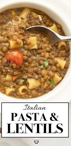 a bowl of pasta and lentils soup with a spoon in it on a white plate