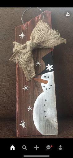 a wooden sign with a snowman on it