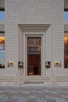 an entrance to a building with stone steps and windows