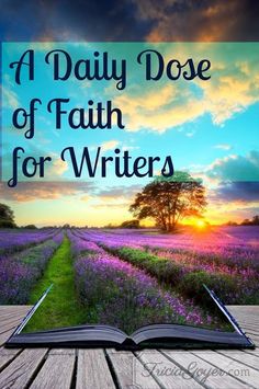 an open book sitting on top of a wooden table next to a field with purple flowers