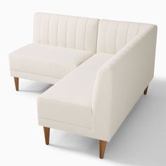 a white couch sitting next to each other on top of a white flooring area