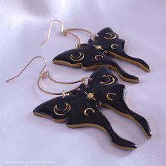 Subtle holographic shimmer accentuates the black polymer clay; gold moons are encased in resin to give strength, shine, and a professional finishing touch. These earrings are sure to make a statement and leave an impression! They measure just under 3 inches long and about 2 inches wide, hang from stainless steel crescent moons and French ear hooks. They are a medium weight, so I do not recommend them for novice earring wearers. The earrings are tough, but I do not recommend wearing in the shower Black Celestial Earrings For Gift, Handmade Black Moon-shaped Earrings, Handmade Black Moon Earrings, Handmade Magical Black Jewelry, Handmade Black Magical Jewelry, Black Resin Party Jewelry, Black Moon-shaped Earrings For Gift, Black Moon Shaped Earrings For Gift, Black Moon Shaped Celestial Earrings