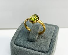 Natural Peridot Ring * Dainty Cabachon Ring * Genuine Peridot & 14K Solid Gold * Best Gift for Her/Him * Handmade Ring ◎ Details ◎ ○ Gemstone Details .Natural PERIDOT Oval Cut 9X7 mm approx. 2.01 ct ○ Gold Details 14K Solid Gold Width of Band : 2.50 mm Weight of Ring : approx 3.80 gr Made to Order HANDMADE ITEM ○ Upgrade to Solid 18K Gold, please click the link below: https://www.etsy.com/listing/962826004 For more CABACHON BEZEL rings : http://etsy.me/37fvI60 ○ PERIDOT RINGS : https://etsy. Gold Domed Gemstone Rings, 14k Gold Rings With Cabochon Round Stone, Yellow Gold Cabochon Ring, Gold Rings With Bezel Setting And Oval Cabochon, Gold Oval Cabochon Birthstone Ring, Gold Oval Cabochon Birthstone Ring With Bezel Setting, Gold Cabochon Gemstones For Anniversary, Gold Peridot Birthstone Ring With Accent Stones, Gold Emerald Ring With Round Stone