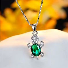 a necklace with a green stone in the center