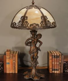 a lamp that is sitting on top of a table next to some books and a book case