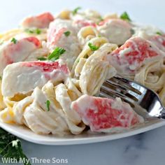 a white plate topped with pasta covered in sauce