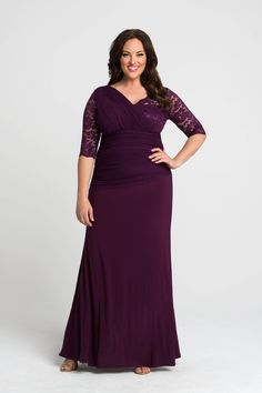 a woman in a long purple dress posing for the camera with her hands on her hips